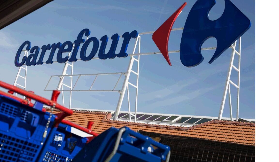 Rótulo de Carrefour sobre tejado y carros de compra azules que ilustran como ahorrar en gasolina usa tu cheque ahorro carrefour.