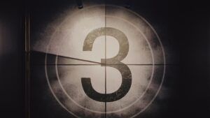 Número 3 grande en un fotograma de cuenta atrás vintage iluminado y texturizado, descubriendo sentido numero una reflexion profunda.