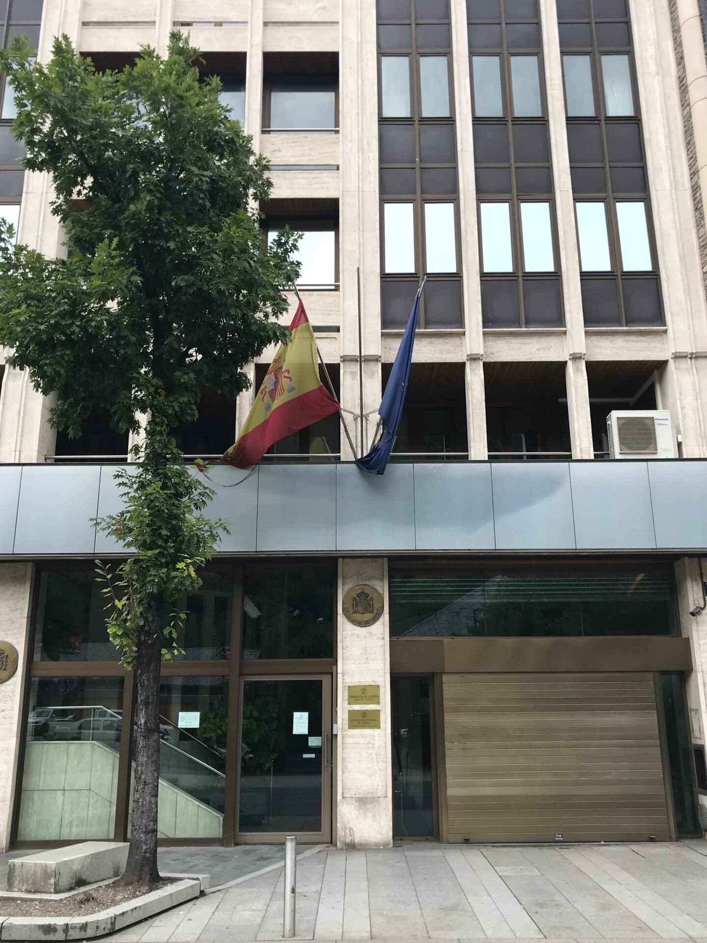 Fachada de edificio con la bandera de España y la bandera europea junto a la entrada principal, donde esta la embajada de espana encuentra su ubicacion aqui 1.