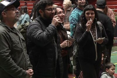 Grupo de personas en evento interior con presentador al micrófono escuchando sobre el fascinante mundo de la alimentacion de las golondrinas todo lo que debes saber