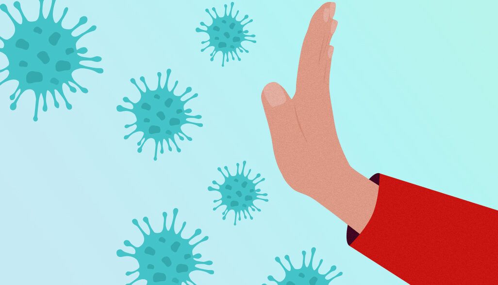 Mano que bloquea partículas virales, fumar con gripe que consecuencias puede tener en tu salud