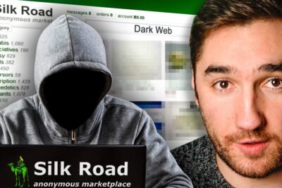 Figura encapuchada frente a un portátil con Silk Road y la página del Dark Web, que significa dea todo lo que necesitas saber sobre esta sigla misteriosa