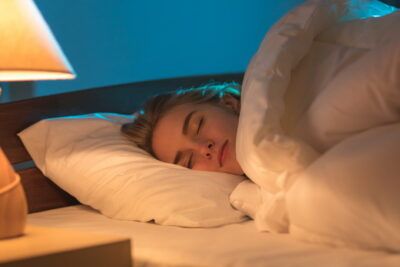 Persona durmiendo en una cama que simboliza el significado de sonar con ser enterrado analisis completo.